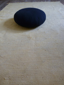 A meditation cushion (zafu). I use mine on top of a soft mat to make it easier on my feet.