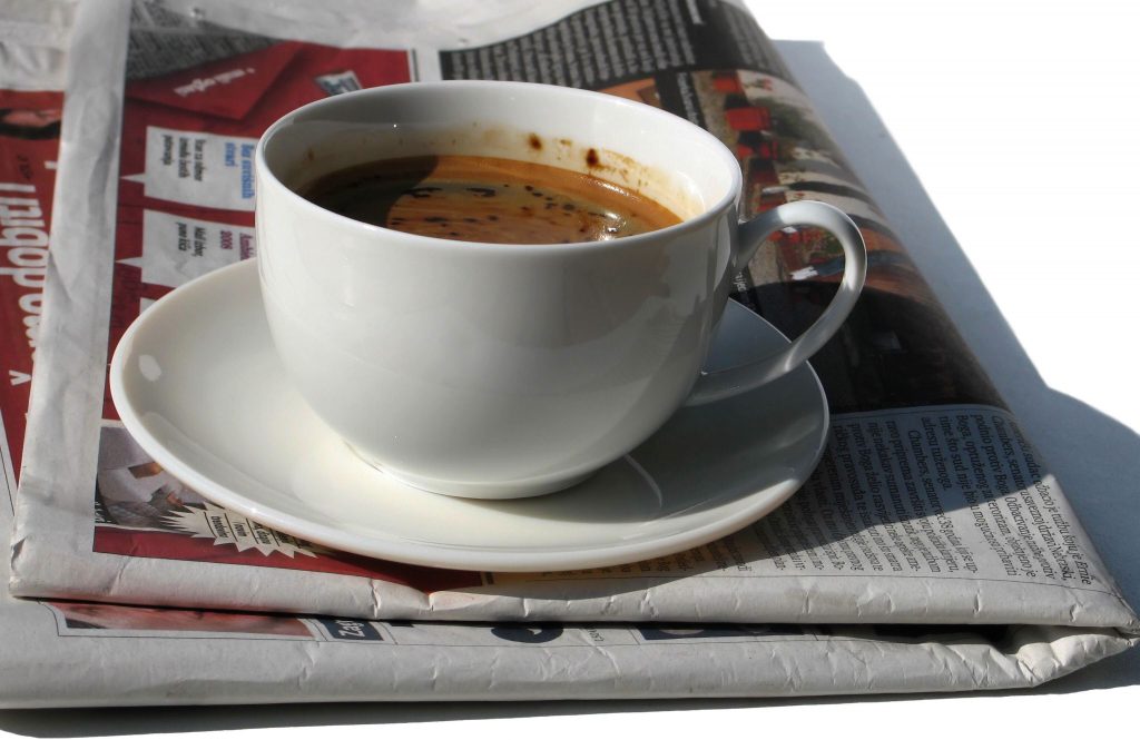 Cup of coffee and a newspaper.
